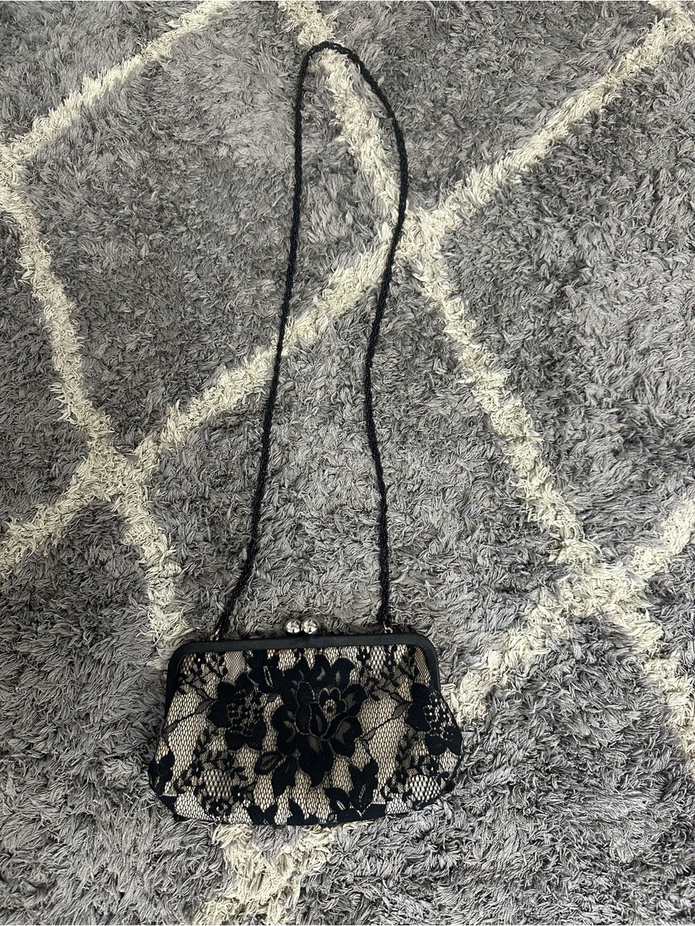 Women’s Black and Beige floral print clutch.